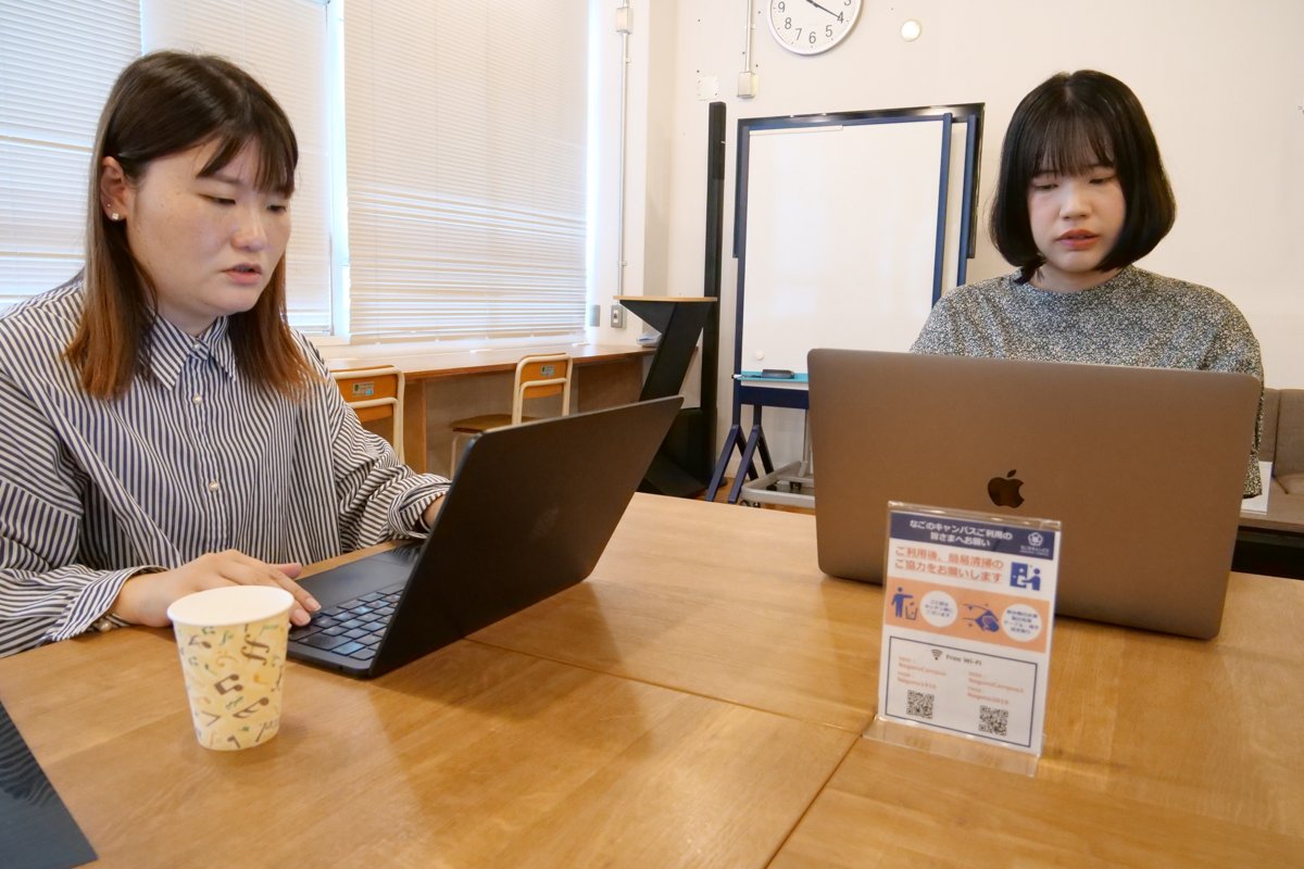 パソコンを並べて案件の資料を確認する高木さんとスタッフ